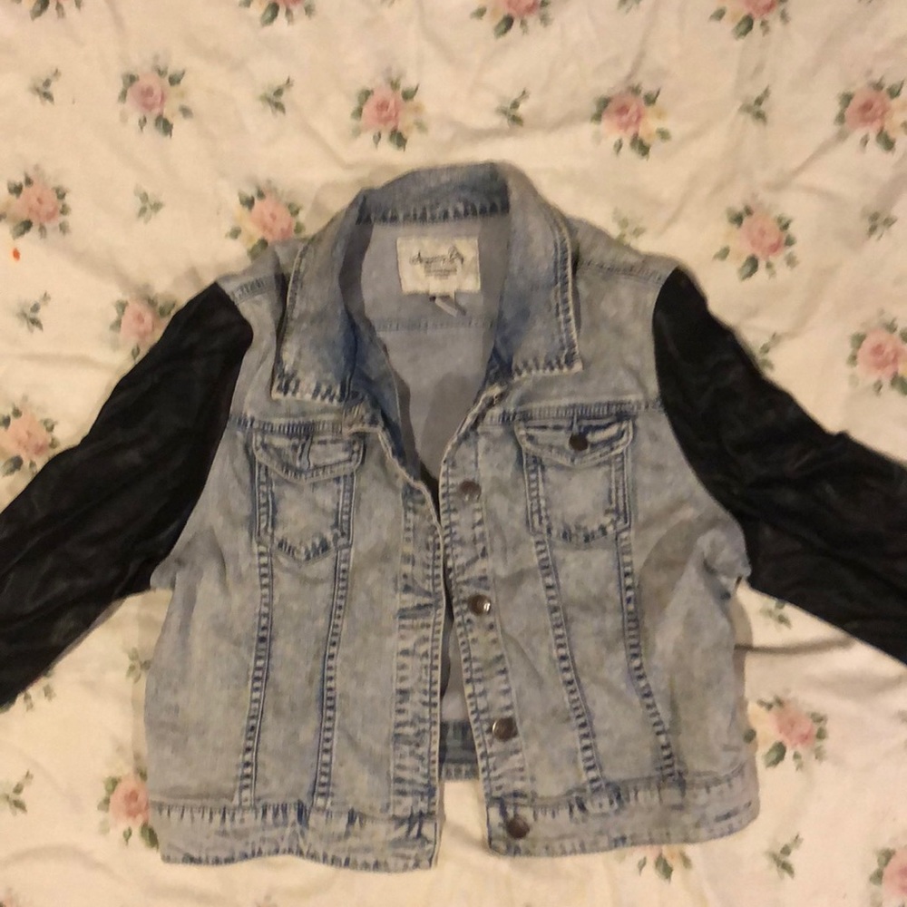 Denim jacket with black leather sleeves